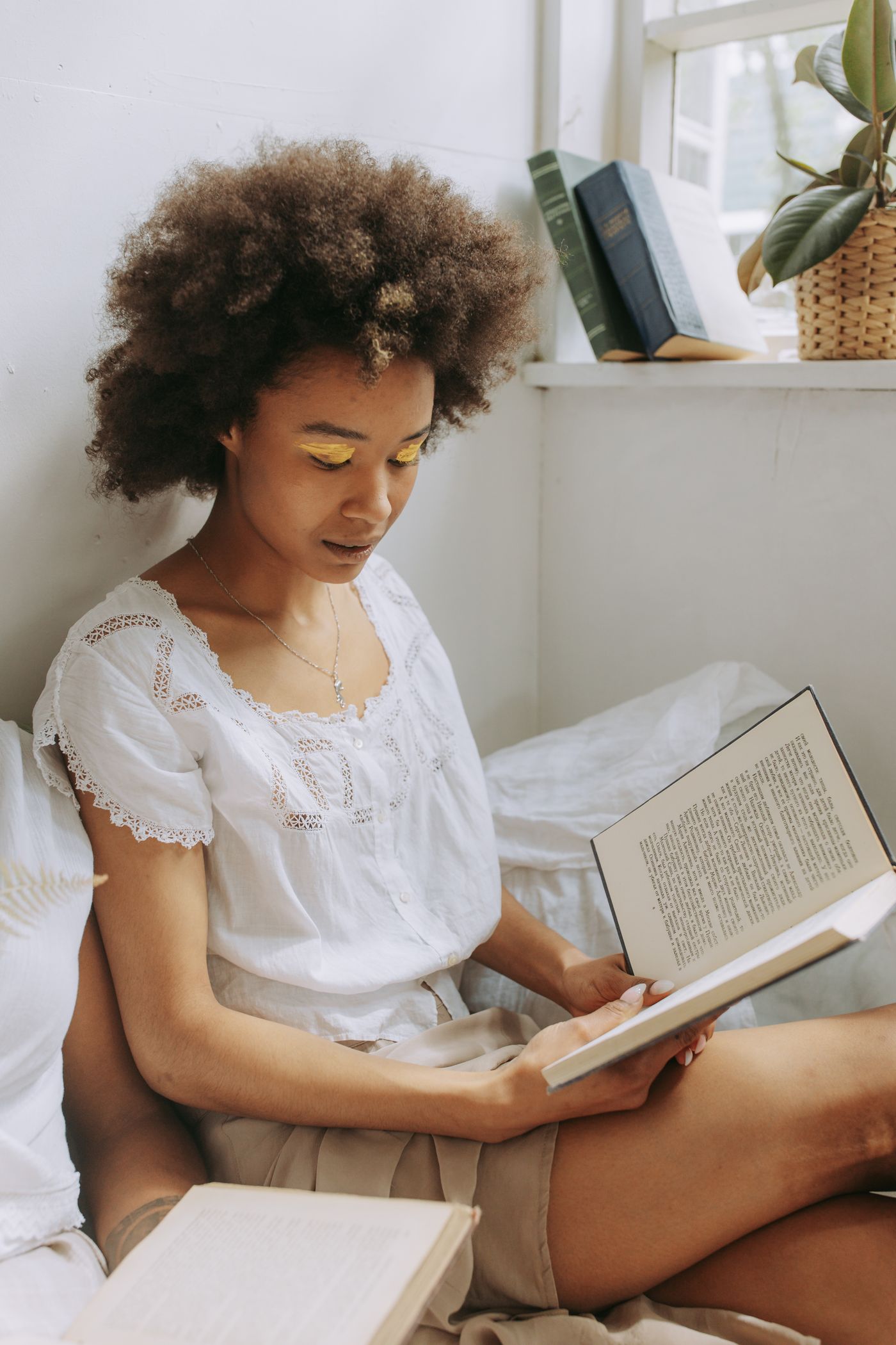 A woman reading a book in warm natural light